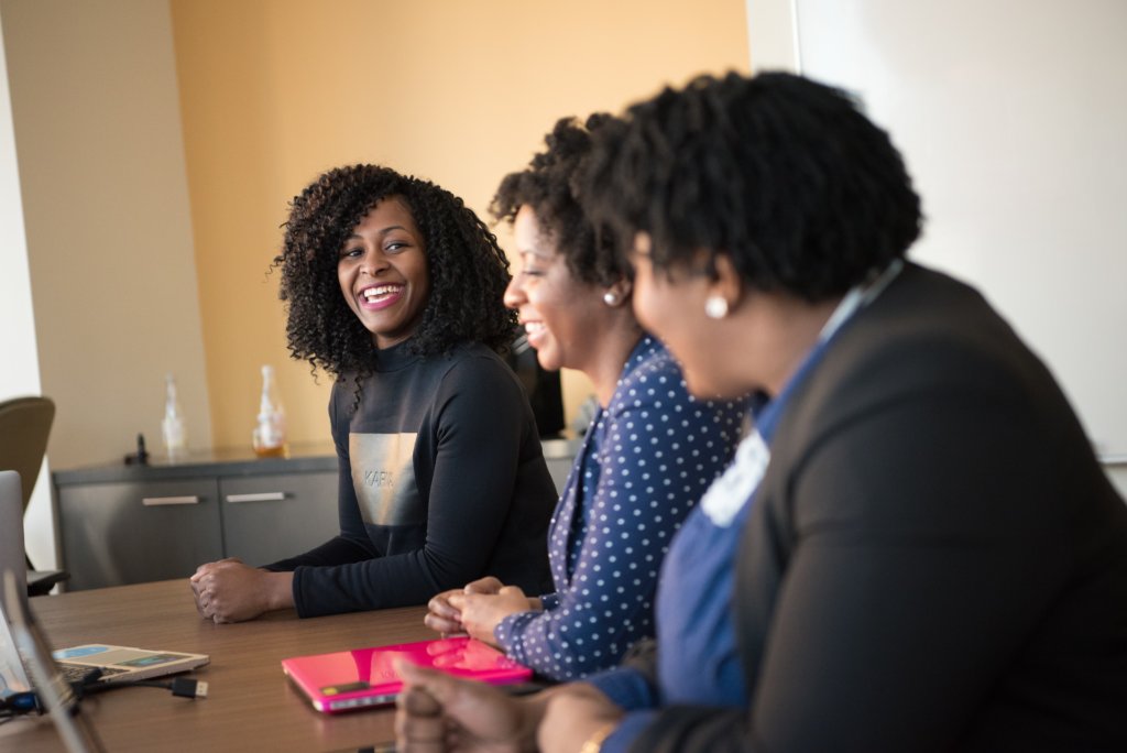 women talking in a conference room during a reverse mentoring session