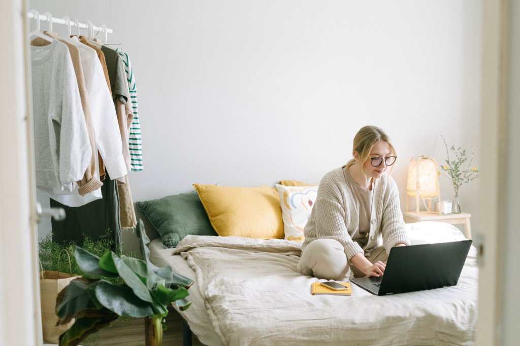 new hire female employee working remotely from home bedroom