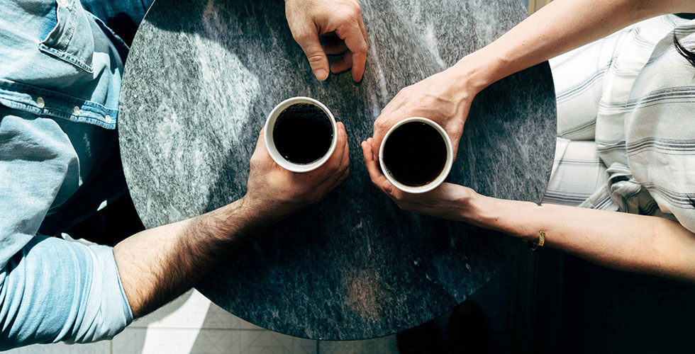 man and woman having coffee during mentoring session