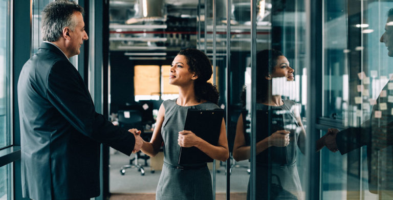 executive-congratulating-women-junior-employee