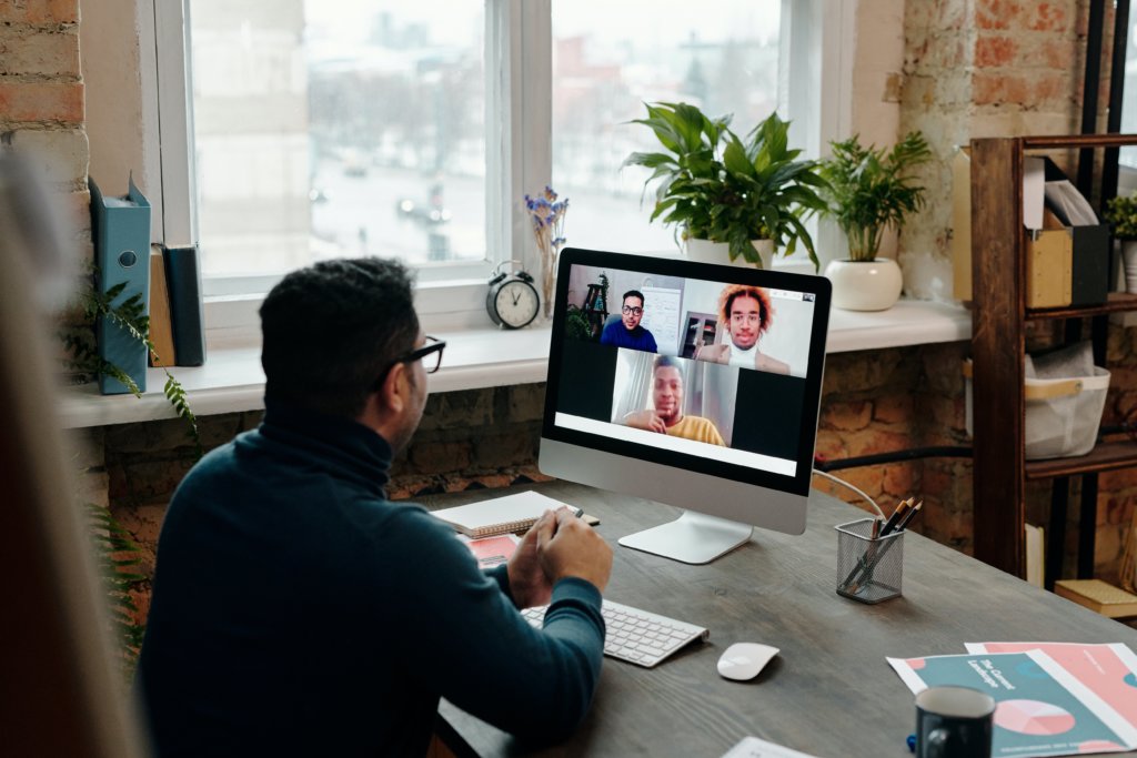 a group of employees engage in a remote mentoring session