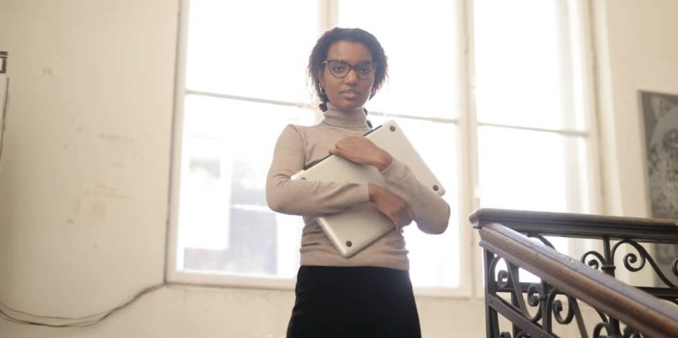 woman carrying computer in stairwell