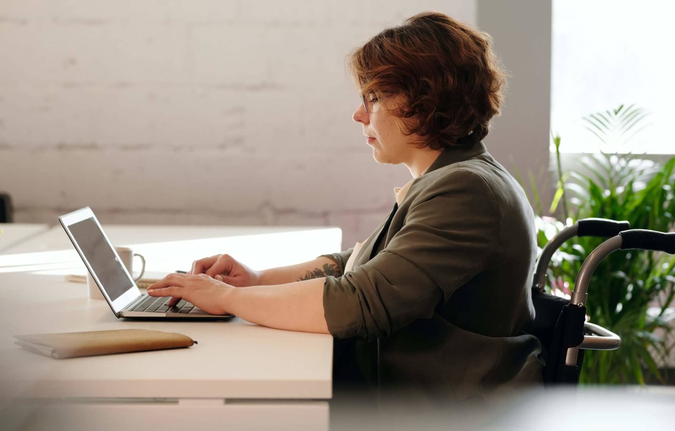 woman in wheelchair using laptop