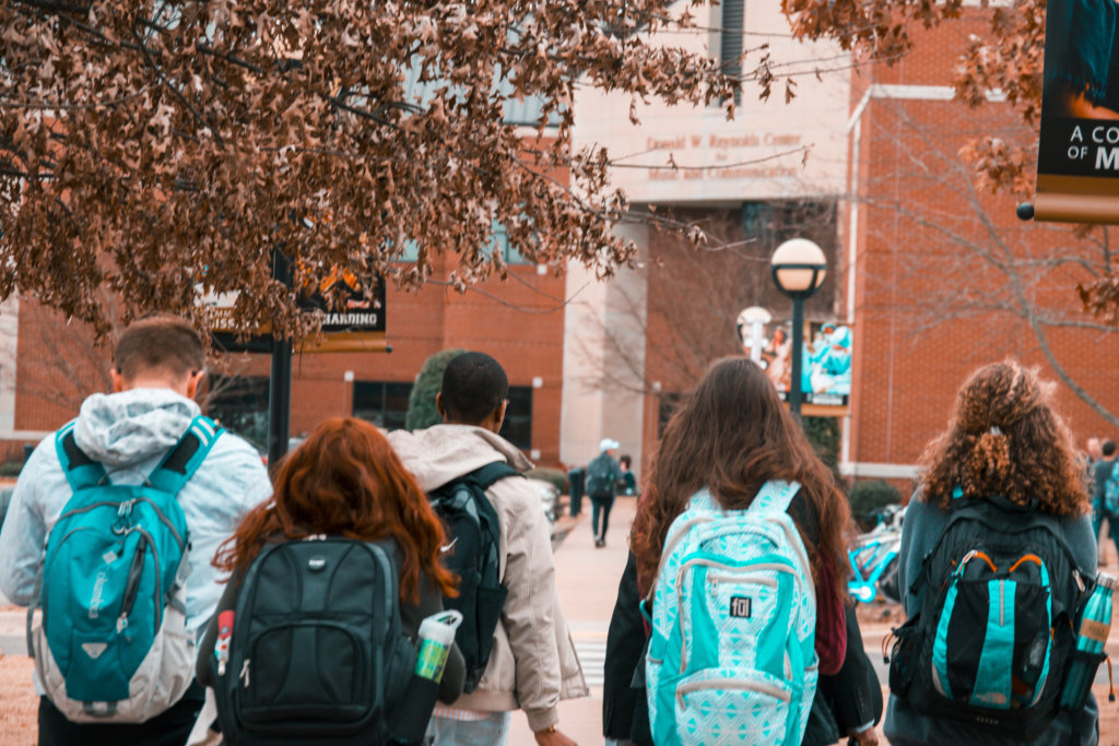 students wearing backpacks on campus