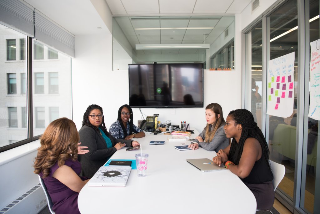 team meeting of diverse women employees in conference room