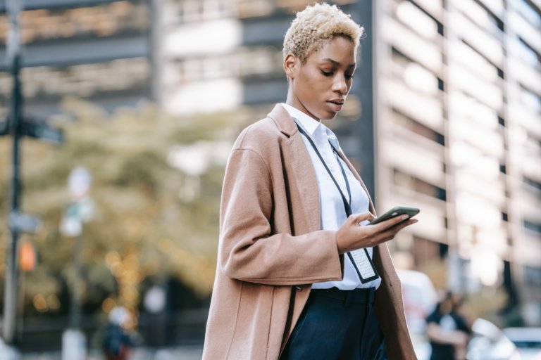 woman mentee engaging with mentorship on her phone