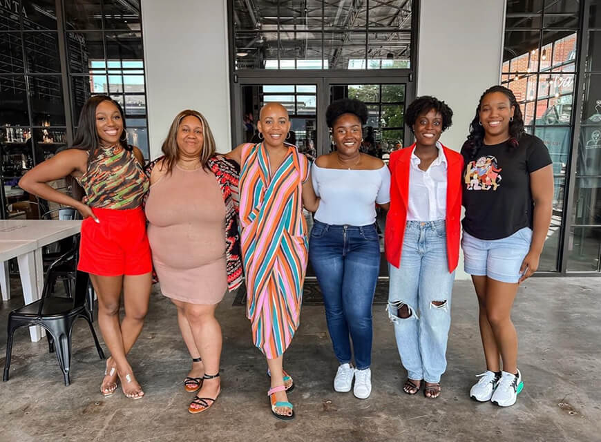 Cohort Sistas women and non-binary participants standing in group during mentoring circle