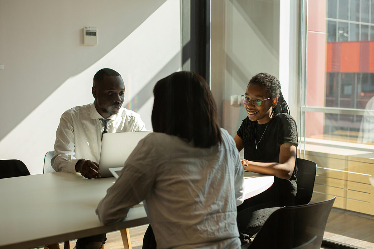 employees sitting at table discussing upcoming business resource group events