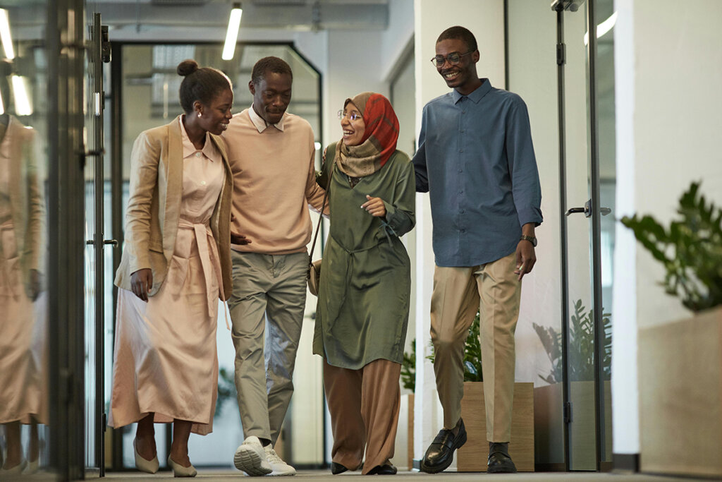 employees walking down hallway of office leaving a business resource group meeting