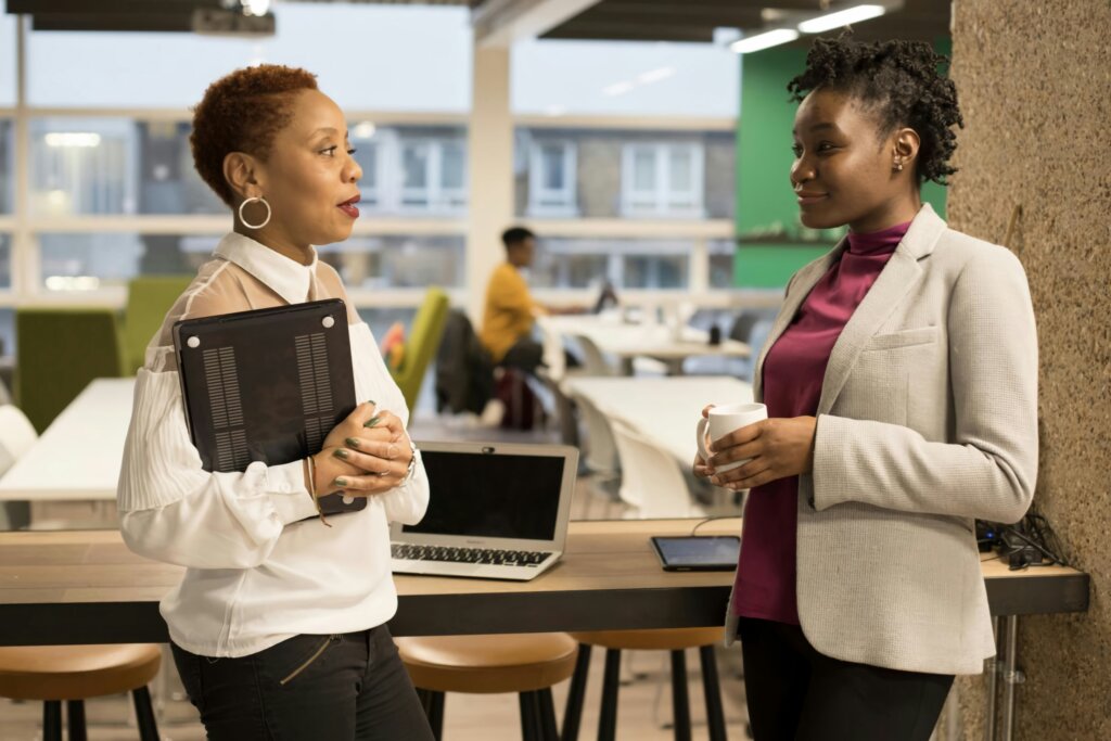 two women employees in a talent development program interacting in a mentoring session.