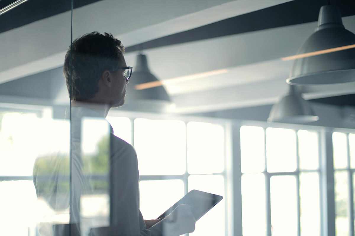 map looking at iPad in a modern office