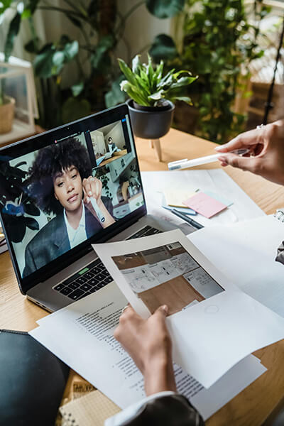 woman in home office on a virtual call with HR leader discussing upskilling employee program