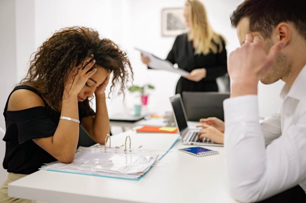 Two professionals sit at a conference table